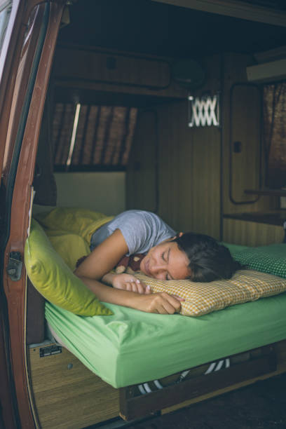 istock Young woman sleeping in a motorhome 1353379626