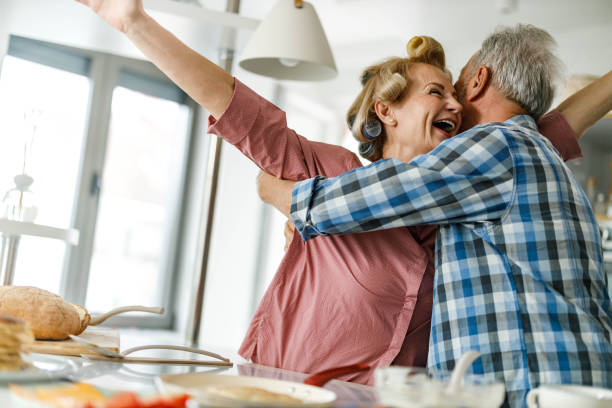 istock Cheerful senior couple having fun in the kitchen. 1353380464