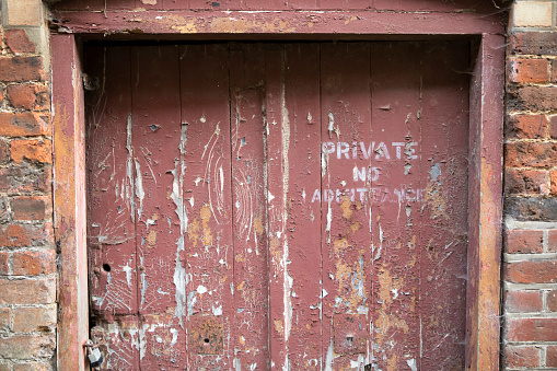 Close-up of a weathered door to an abandoned building