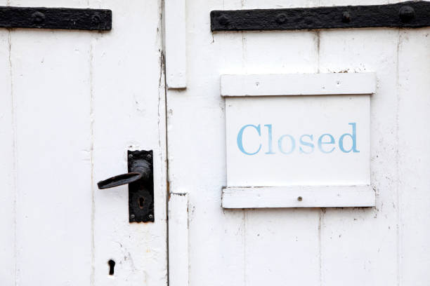 istock Closed sign on a white barn door with black ironwork 1353380574