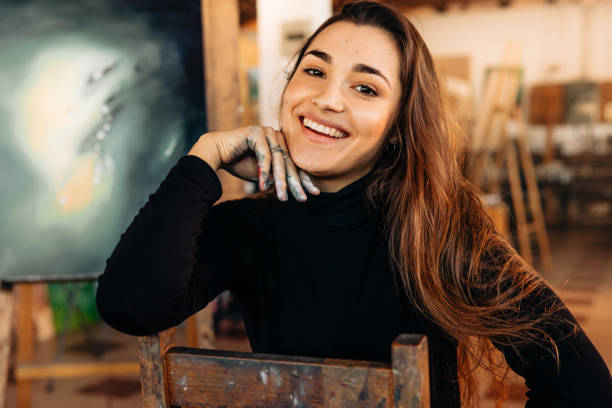 istock Happy professional painter smiling at the camera 1353383999