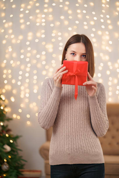 istock Portrait young beautiful woman hold a gift box 1353384161