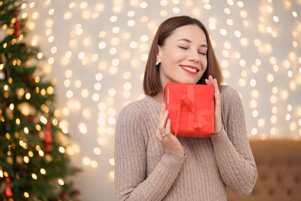 istock Portrait young beautiful woman hold a gift box 1353384257
