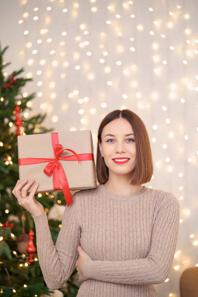 istock Portrait young beautiful woman hold a gift box 1353385273