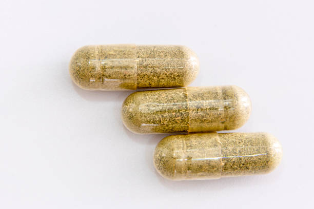 istock Andrographis paniculata pill capsule in green on white 1353385556