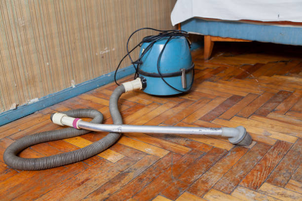 istock Blue vacuum cleaner stands on old parquet floor 1353386821