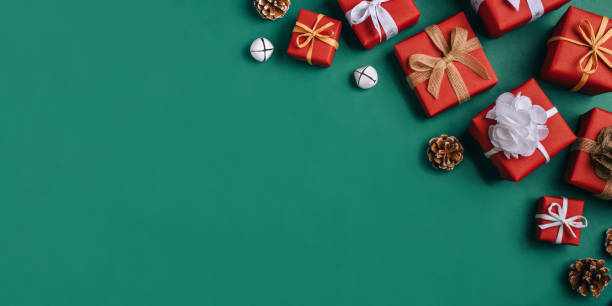 istock Gift boxes with white and brown bows on a green backdrop. 1353386824