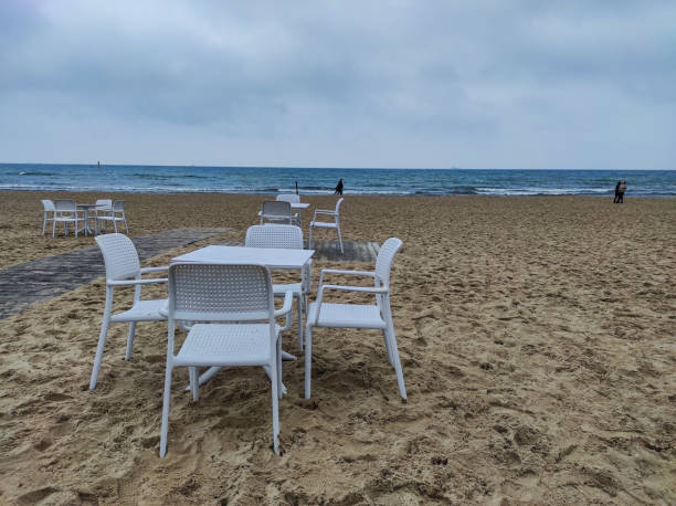 istock Cafe chairs on the sea beach 1353387204