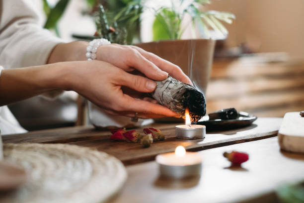 istock Hands burning white sage for ancient spiritual ritual 1353388137
