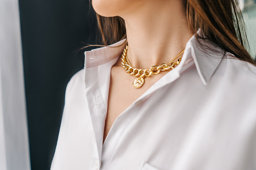 White pearl necklace on blue background