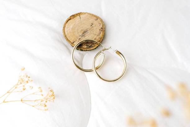 istock Golden modern bijouterie earrings on white background. 1353388172