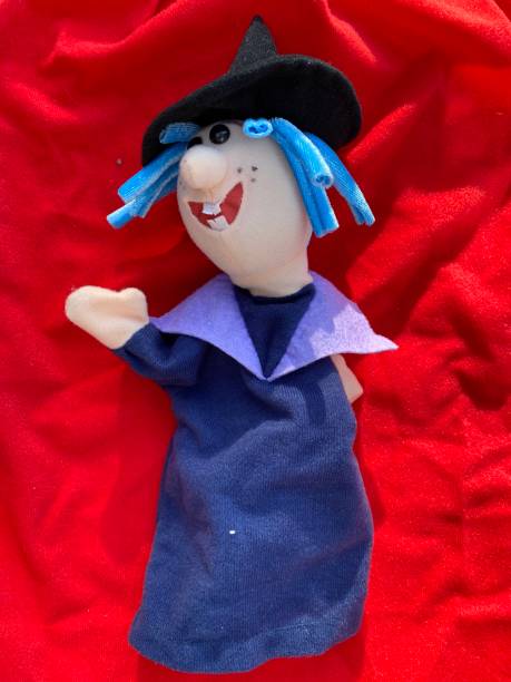 istock Top view of a puppet toy on a red blanket. 1353389203