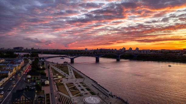 Beautiful sunset in Nizhny Novgorod. Beautiful sunset in Nizhny Novgorod. Aerial view of the city with bridge and new embankment. Colourful sky covered with orange and purple clouds. nizhny novgorod stock pictures, royalty-free photos & images
