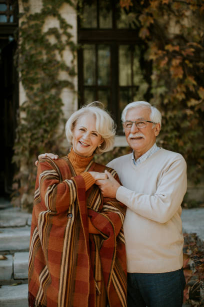 istock Senior couple embracing in autumn park 1353390047