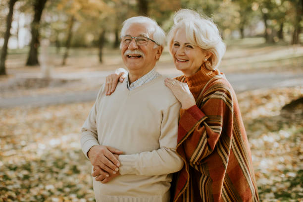istock Senior couple embracing in autumn park 1353390052
