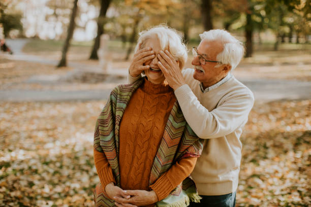 istock Senior couple embracing in autumn park 1353390053