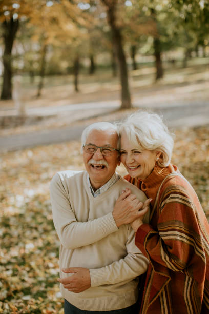 istock Senior couple embracing in autumn park 1353390106