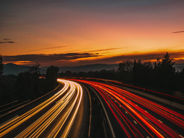 istock Highway with the car lights at night with sunset 1353390140