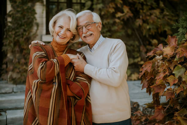 istock Senior couple embracing in autumn park 1353391396