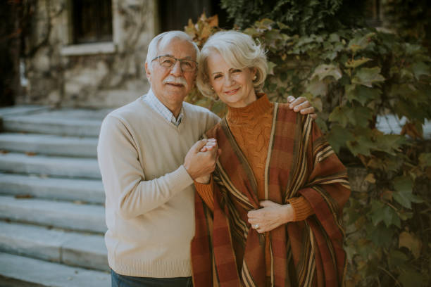 istock Senior couple embracing in autumn park 1353391408