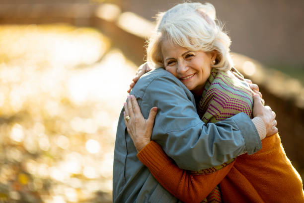 istock Senior couple embracing in autumn park 1353391409