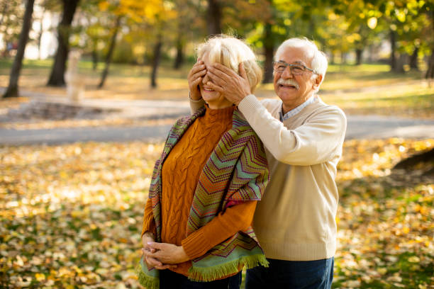 istock Senior couple embracing in autumn park 1353391429