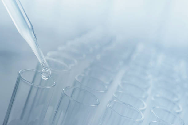 istock Pipette adding fluid to one of several science laboratory test tubes, laboratory equipment 1353393752
