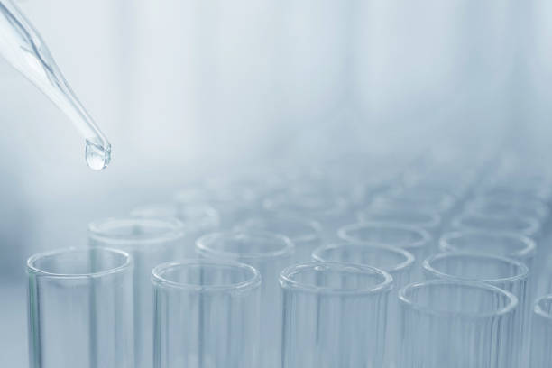 istock Pipette adding fluid to one of several science laboratory test tubes, laboratory equipment 1353393753