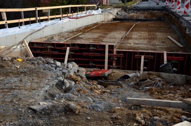 istock Construction work for the reconstruction of a road bridge. wires and nets for concrete reinforcement before applying concrete to the formwork. safety plastic marking the edge of the construction site 1353394566