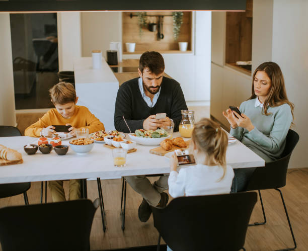 istock Young happy family talking while having lunch at dining table 1353394859