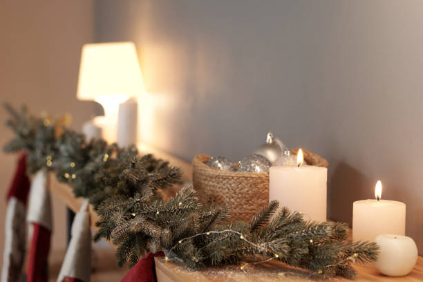 istock Row of white burning candles and decorative coniferous branches 1353399203