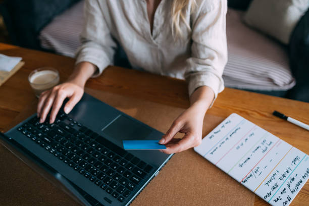 istock An Anonymous Business Woman Making a Credit Card Purchase 1353399711