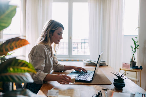 istock Serious Business Woman Using Laptop Computer at Home 1353399725