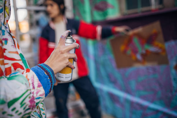 istock Street artists holding spray paint 1353400451