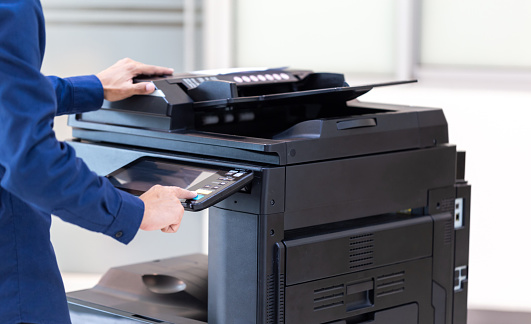 Businessman press button on panel of printer photocopier  network , Working on photocopies in the office concept , printer is office worker tool equipment for scanning and copy paper.