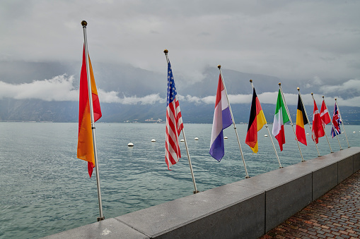 View from Lake Garda Limone Sul Garda with flags. Italy autumn 2021 in the Dolomites