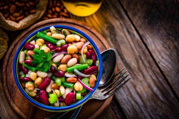 istock Close up of a bean salad bowl on rustic table. 1353402204