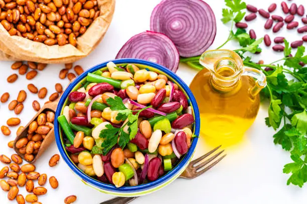 Healthy eating and vegan food: high angle view of a bowl of fresh healthy bean salad shot on white background. High resolution 42Mp studio digital capture taken with Sony A7rII and Sony FE 90mm f2.8 macro G OSS lens