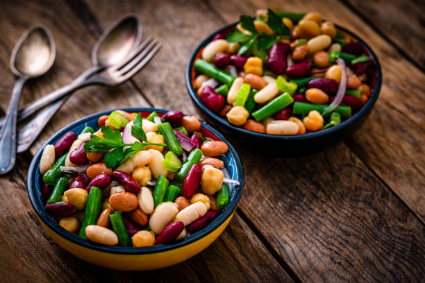 istock Two bean salad bowls on rustic wooden table 1353402278