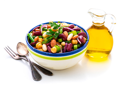Healthy eating and vegan food: close up view of a bowl of fresh healthy bean salad isolated on white background. High resolution 42Mp studio digital capture taken with Sony A7rII and Sony FE 90mm f2.8 macro G OSS lens