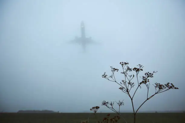 Photo of Airplane approaching for landing in thick fog