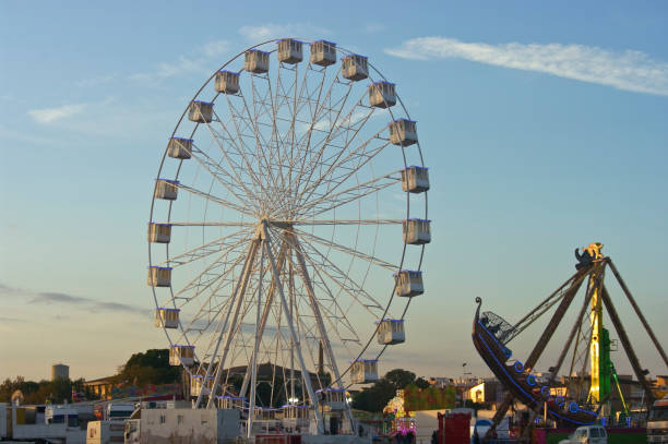 istock Ferris wheel and boat at sunset. 1353403029