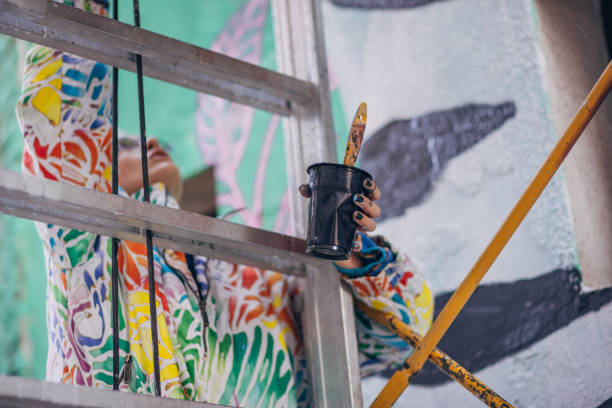 istock Street artist climbing on scaffolding 1353404929