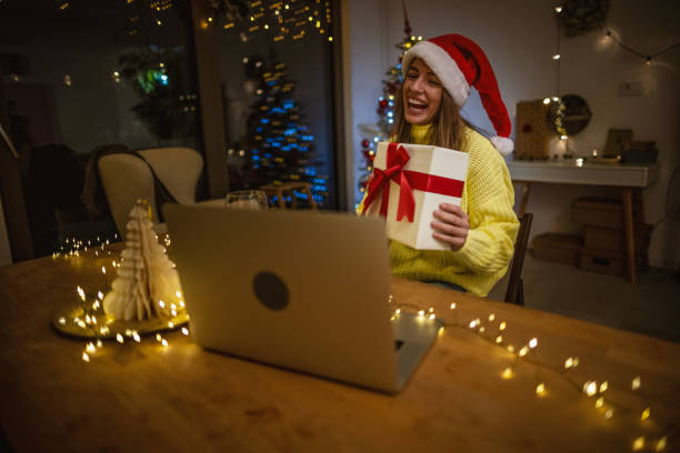 istock Opening Christmas gift during video call with family 1353407028