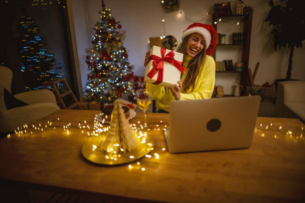 istock Opening Christmas gift during video call with family 1353407056