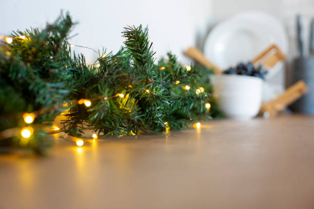 istock light bulbs in coniferous branches on kitchen table. christmas atmosphere.home decor for celebration 1353407117
