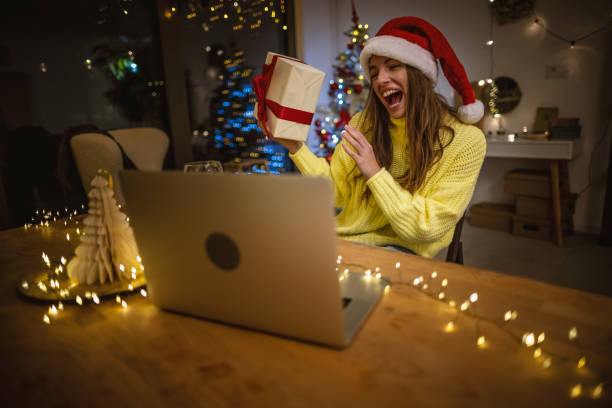istock Opening Christmas gift during video call with family 1353407159