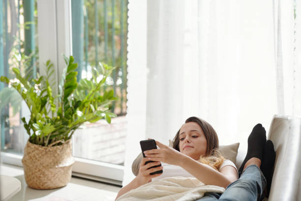 istock Young Woman Lying on Sofa 1353408379