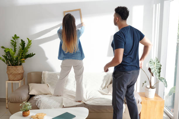 istock Couple Deciding Where to Hang Picture 1353408531