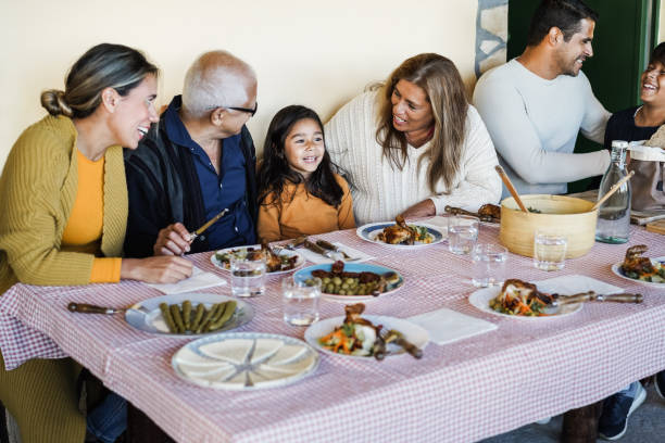happy latin family having fun eating together at finca restaurant - focus on grandmother face - family mother domestic life food imagens e fotografias de stock